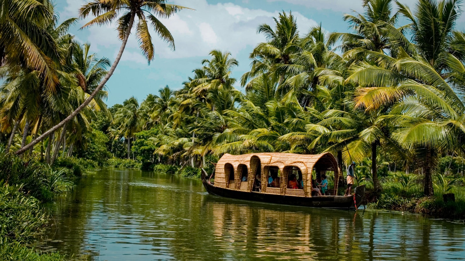 Aerial of Kerala backwaters with houseboats and palm-lined channels