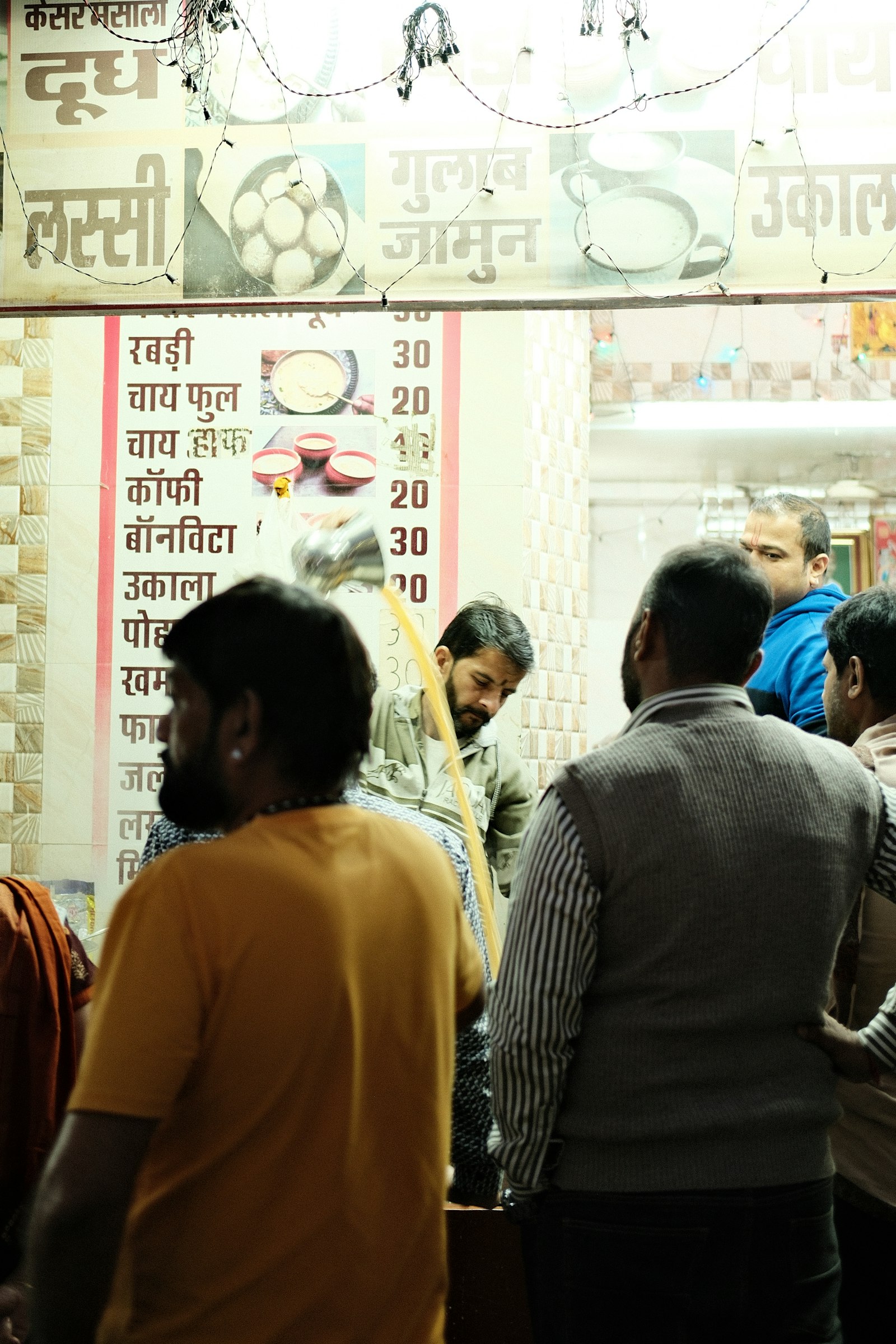 A glass of chai in a steel tumbler at a street stall